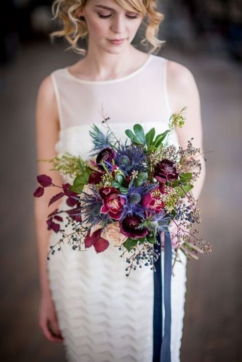 a wedding bouquet with thistle, burgundy and purple blooms Jewel Tone Wedding Flowers, Gorgeous Wedding Bouquet, Autumn Bridal, Blue Wedding Bouquet, Bridal Bouquet Fall, Jewel Tone Wedding, Unique Wedding Flowers, Fall Wedding Bouquets, Fall Wedding Flowers