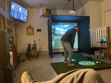 Pics of DIY indoor golf simulators. Golf simulator garage, golf simulator man cave, golf simulator basement. Indoor golf setup at home. Golf Studio Indoor, Golf Simulator In Living Room, Garage Gym And Golf Simulator, Golf House Ideas, Golf Indoor Simulator, Diy Indoor Golf Simulator, Basement Golf Room, House Plans With Golf Simulator, Golf Simulator Room Garage