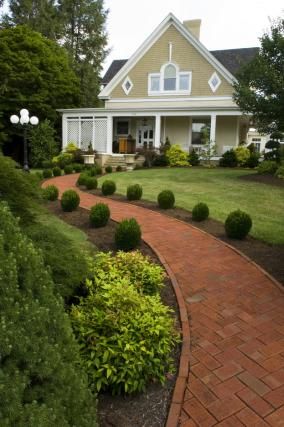 Possibility for our font walk? Jane's garden in Tennessee | Fine Gardening Front Yard Flowers, Brick Sidewalk, Front Lawn Landscaping, Brick Path, Modern Front Yard, Brick Walkway, Front Yard Garden Design, Meteor Garden 2018, Front Landscaping