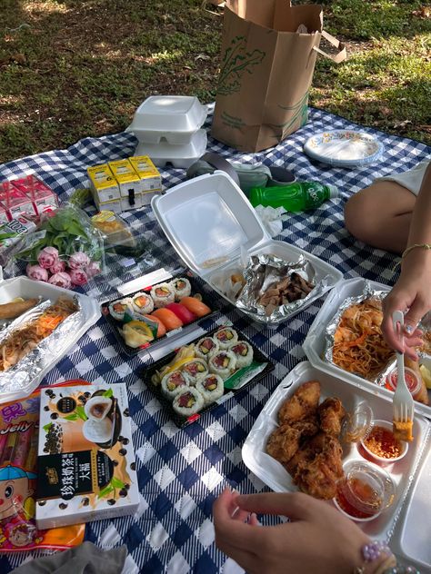 On a blue picnic blanket depicts an array of Asian food ranging from beverages and hot foods. Many hands reach for the food as they are about to eat. Picnic Asian Food, Friend Potluck Aesthetic, Asian Picnic Food, Sushi Picnic Aesthetic, Asian Picnic, Date Ideas Friends, Food Date Ideas, Picnic Date With Friends, Sunshine Activities