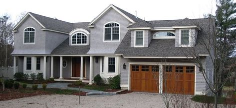 Gray house with wood doors Cedar Shake Siding, Wood Garage, Sectional Garage Doors, Garage Door Types, Garage Door Styles, Cape Cod Style House, Gray House, Wood Garage Doors, Garage Door Design