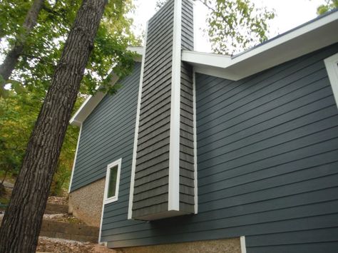 After picture of the side of the house with vinyl shake siding on the chimney. Exterior Chimney Ideas, James Hardie Evening Blue, Chimney Ideas, Vinyl Shake Siding, Farmhouse Paint Colors Interior, Blue Siding, James Hardie Siding, Lake Ozark, Shake Siding