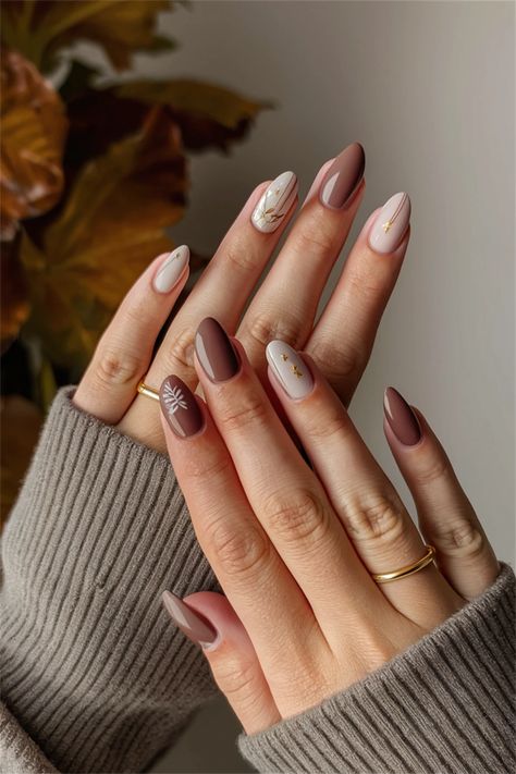 Discover the charm of autumn with these simple nail ideas that capture the essence of Fall. Picture a soft, nude base adorned with delicate golden leaves or cozy plaid patterns in warm hues. This chic yet understated style is perfect for transitioning into the cooler months, offering a blend of elegance and comfort. Whether you're sipping pumpkin spice lattes or enjoying crisp walks through colorful foliage, these nails will match your Fall vibe beautifully! Autumn Transition Nails, Almond November Nails, Oval Nails Autumn, Fall Nails Oval Shape, Fall Inspired Nails Autumn, Soft Autumn Nails, Brown Neutral Nails, Autumn Nails Ideas Simple, Nude Autumn Nails