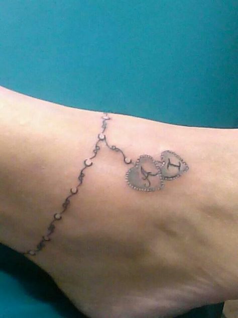 I want something similar to this but with 2 charms and names of my girls with their birth dates. Maybe? Charm Anklet Tattoo, Charm Bracelet Tattoo, Tattoo Ankle, Ankle Tat, Kid Name Tattoo, Rosary Tattoo, Ankle Bracelet Tattoo, Ankle Tattoo Designs, Tattoos With Kids Names