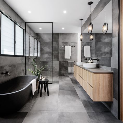 A modern master bathroom with a grey color palette, a freestanding bathtub, and a shower for two. Modern Bathroom Design Grey, Grey Bathroom Floor, Light Grey Bathrooms, Dark Gray Bathroom, Grey Bathrooms Designs, Contemporary Bathroom Decor, Grey Bathroom Tiles, Grey Interior Design, Bathroom Color Schemes