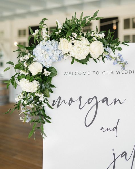 The little details and the pops of hydrangea blue 🩵 all the best things from a Southern wedding in the Summertime. _______________________________ Photography | @brittanylowephotos Videography | @gibbyvisuals Planning + Design | @thehiveweddingco @heatherwiththehive Venue | @uppershirleyweddings Beauty | @ave42salon Bridal Gown | @annalisebridal Florals | @weddingsbyvogue Cake | @pearlsbakeshoppe Rentals | @partyperfect804 Band | @10spotband Ceremony Musicians | @quincesq Suits ... Wedding Sign Florals, Welcome Sign Wedding Flowers, Summertime Photography, Hydrangea Flower Arrangements, Blue Hydrangea Wedding, Hydrangea Blue, Fake Hydrangeas, Hydrangea Arrangements, White Wedding Theme