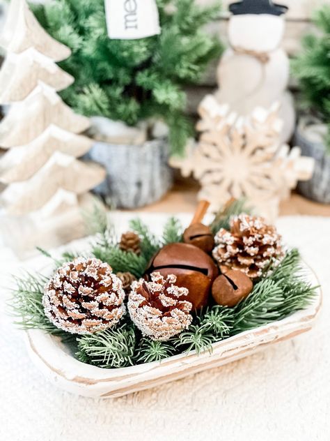 "This evergreen filled dough bowl is perfect for all of your winter displays.  Filler pieces include evergreen,  pinecones, rustic bells, and cinnamon sticks.  ⚠️⚠️ Please note: smaller bells may be white distressed instead of brown as pictured depending on product availability. ⚠️⚠️ Bowls measure approximately 6\"x9\" but variation will occur as each bowl has been handcrafted (not by me). Bowls are painted white and rustic in nature.   Filler pieces are not attached so you can reuse the bowl af Indoor Christmas Floral Arrangements, Christmas Bowl Fillers Ideas Centerpieces, Bread Bowl Decor Centerpieces Winter, Winter Dough Bowl Decor After Christmas, Winter Dough Bowl Centerpiece, Dough Bowl Christmas Decor, Wood Bowl Christmas Centerpiece, Christmas Decor Ideas For Living Room Coffee Tables, Wooden Dough Bowl Centerpiece