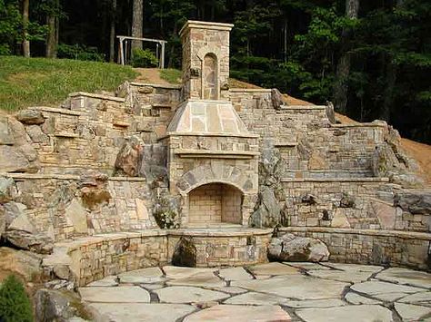 Stone fireplace within retaining wall Patio Fireplace Diy, Diy Retaining Wall, Stone Fireplace Designs, Natural Stone Fireplaces, Landscaping Retaining Walls, Backyard Fireplace, Patio Fireplace, Stone Walls, Retaining Walls