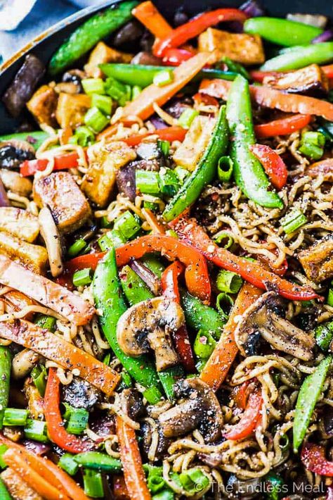 This vegetarian noodle stir fry recipe is a savior for busy weeknights. It's stir-fried veggies, chewy noodles, and crispy tofu tossed in a delicious homemade sauce. It's super versatile, so you can use whatever veggies you find in your fridge, and it's ready in only 30 minutes! #theendlessmeal #noodles #asiannoodles #ramen #stirfry #vegetablestirfry #30minute #vegetarian #vegan #glutenfree Chewy Noodles, Vegetarian Noodles, Fried Veggies, Vegetarian Ramen, Noodle Stir Fry, Asian Stir Fry, Stir Fry Recipe, Stir Fry Noodles, Ginger Sauce