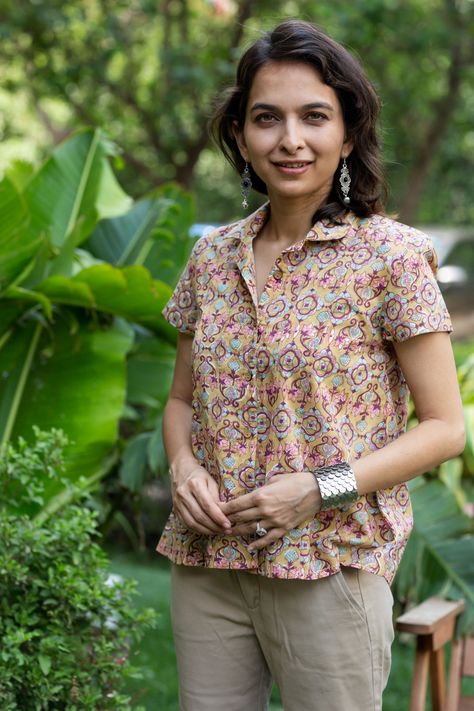 The beige cotton shirt boasts a stunning multi-color handblock print, adding an artistic touch to its design. Wooden button highlights and a collar neck elevate its charm, while the half sleeves ensure comfort and style. A perfect fusion of traditional art and contemporary fashion. Shirt Color Neck Kurtis, Ethnic Shirts Women, Short Kurtis For Jeans Cotton Style, Short Kurtis For Jeans Cotton, Short Tops For Jeans, Short Kurtis For Jeans, Short Kurti For Women, Short Kurti Designs, Cotton Short Tops