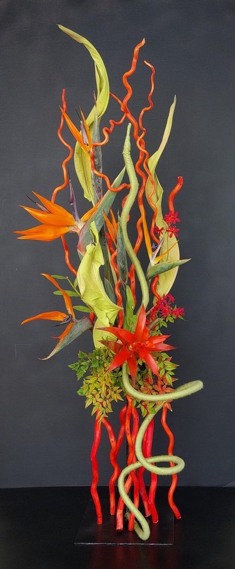 Floral Competition Design, Flower Arrangement Competition, Hanging Heliconia Arrangement, Multi Rhythmic Floral Design, Demonstration Ideas, Tropical Flower Installation, Gloriosa Arrangement Floral, Floral Designs Arrangements, Orchid Flower Arrangements