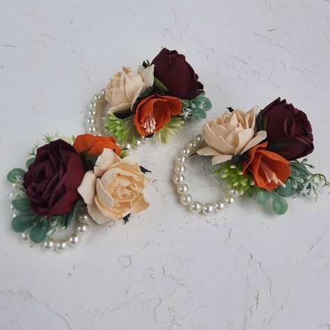 This corsage with burgundy champagne orange fake roses will be perfect your fall wedding party. Created with handmade rusty burnt orange and ivory, burgundy roses.  The corsage comes as a artificial pearls wrist corsage. PLEASE FELL FREE TO MESSAGE ME IF YOU HAVE ANY QUESTION Orange Wrist Corsage, Orange Champagne, Floral Boutonniere, Wrist Corsage Wedding, 40th Anniversary Party, Bridesmaid Corsage, Fall Wedding Hairstyles, Rustic Boutonniere, Burnt Orange Weddings