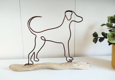 This Doberman is handmade from aluminium wire and stands on driftwood. Perfect for any Doberman fan and the ideal unusual gift for a dog lover. You can also choose to add a wire written name to your dog to add a special personalised touch! Please select which colour wire you would like him made from (see pictures for colours), and whether you would like to add a name. Each item is uniquely made with a carefully selected piece of driftwood to fit the dog! The wire dog measures approx 15x14cm, the pieces of driftwood vary slightly in size - please handle with care as he is very fragile! Please note, these items are handmade to order and so will look very similar, but not identical to the image shown. I have many dog breeds and other wiry animals available - please see my other listings. I'm Wire Dog, Patterdale Terrier, Wire Wall Art, Wire Ornaments, Dog Presents, Wood Dog, Unusual Gift, Dog Items, Wire Sculpture