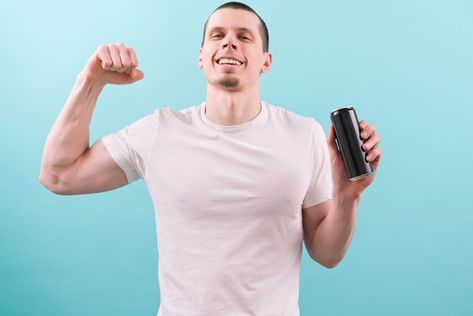 A man in a white tshirt smiles holds an ... | Premium Photo #Freepik #photo #drink-can #beer-can #soda-can #tin Product Mockup, Aluminum Can, Image Collection, Premium Photo, Blue Background, Blue Backgrounds, White Tshirt, Art Inspo, White Undershirt