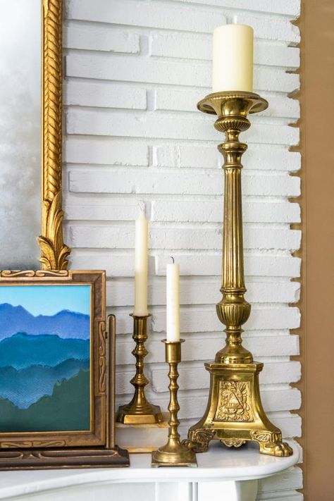 40 Ways to Decorate Your Mantel | How to Decorate a Fireplace Mantel Year Round | HGTV Mantle Styling Traditional, Classic Mantel Decorating Ideas, Classic Mantle Decorating Ideas, Traditional Mantle Ideas, Candlesticks On Fireplace Mantle, How To Decorate With Brass Candlesticks, Traditional Mantel Decor, Narrow Mantle Decorating Ideas, Antique Mantel Decorating Ideas