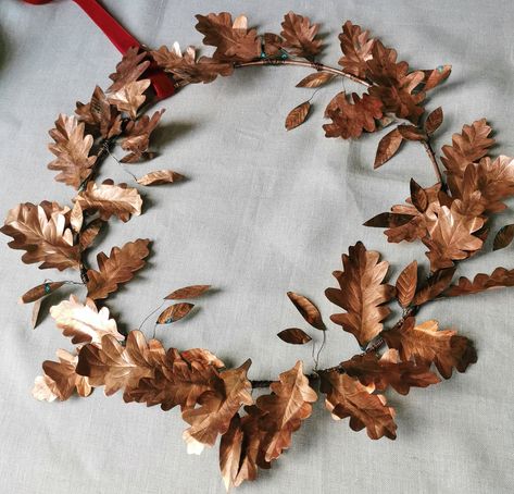 "A beautiful year round copper metal wreath, hand crafted by Debbie in her studio in Ireland. Hand trimmed and sculpted pure copper oak leaves are carefully veined and entwined around a solid copper ring. Finished with a deep ochre or crimson pure velvet ribbon. Due to the natural materials of this wreath it will patinate gently with time, only adding to it's beauty. Hangs with a small hook, simply place on a door, walls or fireplaces to bring the beauty of nature indoors.  DETAILS Pure copper. Copper Christmas Wreath, Copper Wreath, Oak Wreath, Copper Christmas Decor, Twig Wreaths, Acorn Decorations, Copper Christmas, Irish Decor, All Season Wreath