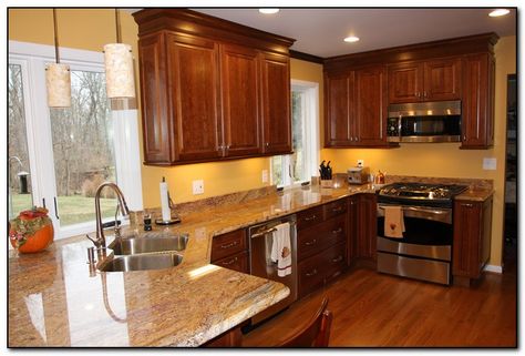 cherry cabinets-gold walls-light countertops Cherry Cabinets Kitchen Wall Color, Cherry Wood Kitchen Cabinets, Cherry Wood Kitchens, Best Kitchen Colors, Trendy Kitchen Colors, Paint For Kitchen Walls, Light Wood Cabinets, Oak Kitchen Cabinets, Brown Cabinets