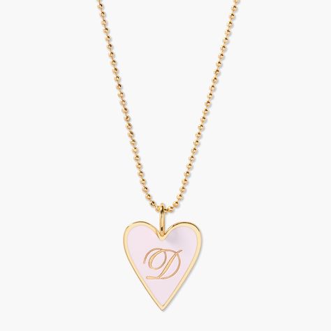 The Margaret Enamel Heart Pendant will add a touch of love to your look. Crafted with a shining enamel finish, this pendant is sure to make your outfit beat with style! (See what we did there?) It's perfect for showing your love and your fashion sense at the same time. Enamel filled pendant measures 3/4"x1", gold plated sterling silver 16" brass diamond cut ball chain with 2" extender Lobster claw closure With engraving this item is FINAL SALE SKU: BYN1439 Jewellery Wishlist, Girly Stuff To Buy, Cute Pink Heart Charm Necklace, Cute Pink Heart Pendant Necklace, Pink Heart Pendant Jewelry, Gold Enamel Heart Charm Necklace, Gold Heart-shaped Enamel Necklace, Enamel Locket, Initial Charm Bracelet