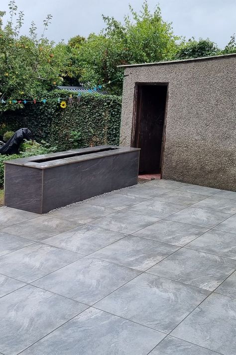 The Grey Porcelain Outdoor tiles add a dramatic dark style to a garden space making lawns look more vibrant and flowers stand out. Inject a sense of pure luxury & style into your exterior with our dark grey outdoor tiles. Dark grey outdoor tiles are slip and frost resistant. Order a free samples now. #outdoor #outdoortiles #paving #pavingslabs outdoor tiles dublin outdoor tiles ireland paving slabs dublin garden tiles dublin garden tiles ireland paving slabs ireland outdoor porcelain tiles Grey Outdoor Tiles, Tiles Garden, Outdoor Porcelain Tile, Outdoor Tile, Flowers Stand, Patio Slabs, Garden Tiles, Patio Tiles, Paving Slabs