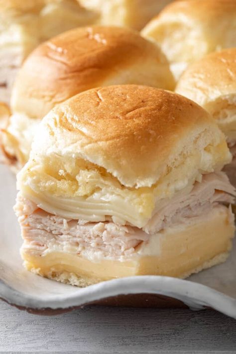 These Turkey and Cheese Sliders made with leftover turkey breast or sliced deli, two types of cheese and Bechmel sauce, will take your slider game to the next level. Warm Hawaiian roll turkey sliders are perfect for holiday parties, game day, potlucks or a quick go-to for lunch or dinner. Leftover Turkey Breast, Turkey And Cheese Sliders, Hawaiian Roll Turkey Sliders, Sliders Recipes Turkey, Sliders Recipes Hawaiian Rolls, Easy Slider Recipes, Hawaiian Roll Sliders, Rolled Sandwiches, Turkey Sliders