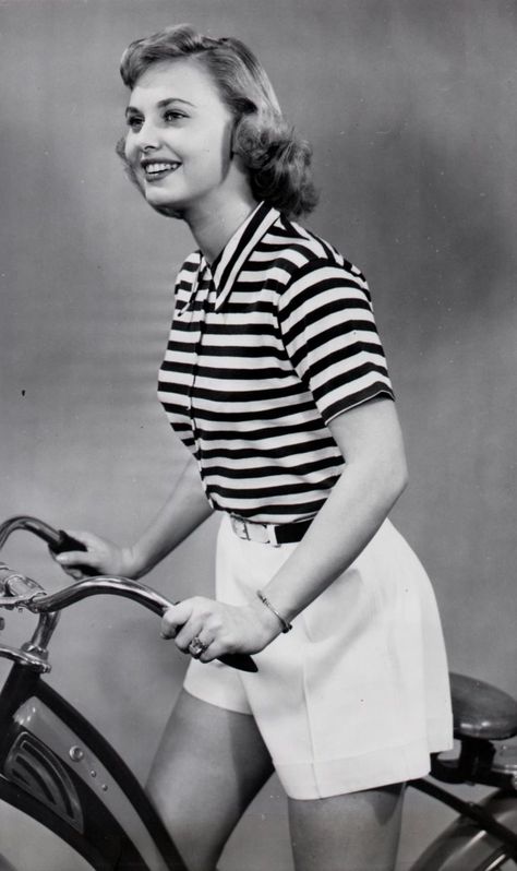 Lola Albright models a bike, and models bike clothes.“IDEAL FOR CYCLING– At home with shorts, slacks or pedal-pushers, this versatile cotton T-shirt is done in brilliant green-and-white stripes. It has short sleeves and buttons up to a neat turn-down collar. Actress LOLA ALBRIGHT likes it for cycling.” – Acme News, March 23, 1949 Cycling At Home, Lola Albright, Pedal Pushers, Bicycle Women, Bike Clothes, Bicycle Girl, The Girlfriends, Old Hollywood Glamour, Hollywood Glamour