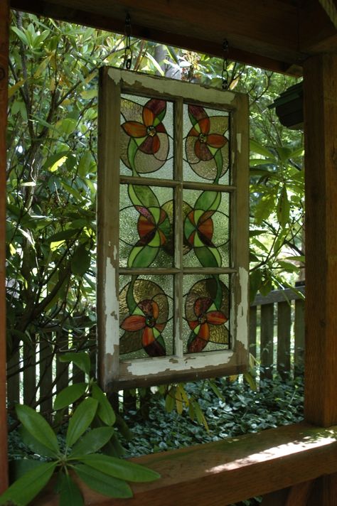 An old window, glass scraps -- voila! I love hanging stained glass pieces outdoors. Hanging Stained Glass In Front Of Window, Hanging Stained Glass Window, Hanging Stained Glass Panels In Window, Stained Glass Hanging In Window, Hanging Stained Glass Panels, Garden Window Ideas, Window Upcycle, Glass For Wedding, Old Window Art