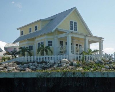 What's better than the beach?  A yellow house on the beach. Yellow Beach Cottage, Cute Yellow House, Yellow Beach House Exterior, Pale Yellow House Exterior, Beach Shack Exterior, Yellow Beach House, Tin Roof House, Little Cottage House, Exterior Design Backyard