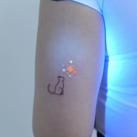 Cat Glow In The Dark Tattoo 1 Glow In The Dark Tattoos For Women, Glow In The Dark Tattoo Ink, Glowing Butterfly Tattoo, Neon Ink Tattoo, Light Color Tattoo, Glow Worm Tattoo, Glow In Dark Tattoo, Tattoo Glow In The Dark, Uv Ink Tattoos For Women