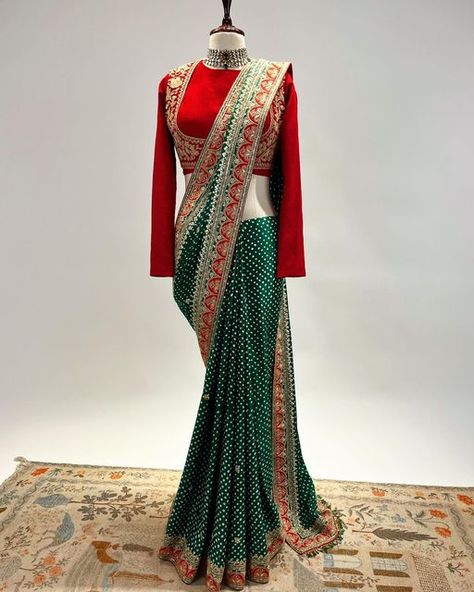 NIDHI TAMBI KEJRIWAL on Instagram: "A Bottle green and Red Bandhej Saree in Marodi and gota work with a classic full sleeves blouse. For enquiries, orders and customisations, kindly connect with our teams over whatsapp at +91 8860558705 or +91 8591639131 or email us at info@nidhitambikejriwal.com For more info, visit www.nidhitambikejriwal.com #sharara #marodi #bandhej #bandhani #heritageclothing #nidhitambikejriwal #ntkdesigns" Blouse Designs For Bandhani Sarees, Green Bandhani Saree, Full Sleeves Blouse, India Wedding Dress, Full Sleeves Blouse Designs, Bandhej Saree, Blouse Designs High Neck, Full Sleeve Blouse, Reception Look