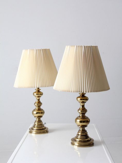 "This is a pair of vintage Stiffel brass table lamps.  The classic baluster style lamps have their original pleated shades.   CONDITION In good, working condition with wear consistent with age and use.  Wiring as found.  MEASUREMENTS Height:  27.75\"  ..  70.5 cm Height to Finial:  27.5\"  ..  69.9 cm Height to Socket:  19.25\"  ..  48.9 cm Base Diameter:  6.5\"  ..  16.5 cm Shade Diameter:  16\"  ..  40.6 cm 423121" Vintage Inspired Interior, Brass Lamp Styling, Vintage Gold Lamp, Vintage Pleated Lamp Shade, Stiffel Lamps Vintage, Stiffel Brass Lamps Vintage, Brass Bedside Lamp, Cute Vintage Lamps, Antique Brass Lamp