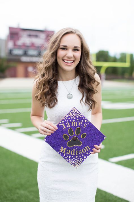 Graduation pictures for cheerleader taken on the football field senior year. Decorated James Madison University (JMU) graduation cap #GoDukes #AshleyPowellPhotography Graduation Pictures On Football Field, Jmu Graduation Cap, Graduation Photo Ideas, College Graduation Photoshoot, Grad Cap Designs, Grad Pic, James Madison University, Graduation Photography Poses, Grad Caps