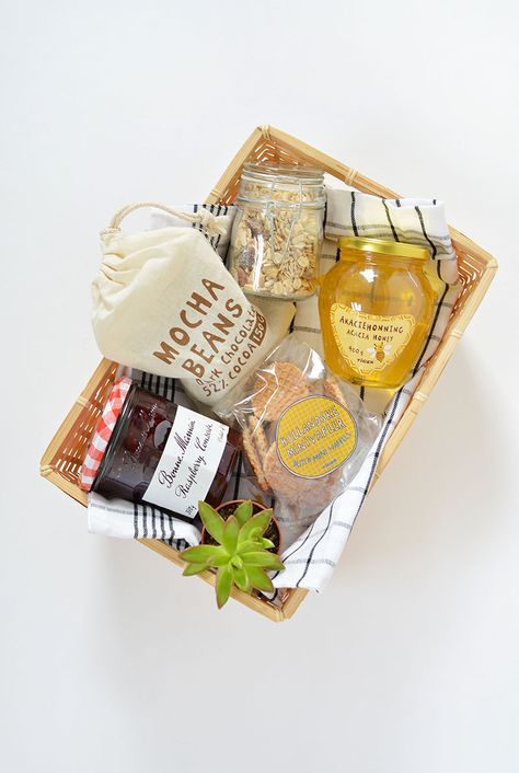 A lovely breakfast gift basket - love the addition of a wee plant!                                                                                                                                                                                 More Breakfast Baskets Ideas Gift, Breakfast Hamper Ideas, Breakfast Basket Gift Ideas Mornings, Food Box Gift Ideas, Breakfast Package Ideas Food Gifts, Breakfast Box Packaging, Breakfast In Bed Gift Basket, Breakfast Gift Basket, Breakfast Basket