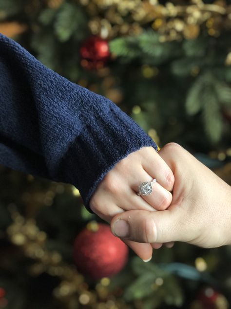 1.5 carat unique white gold engagement ring with Christmas tree - holding hands #engagementrings #christmasengagement #whitegoldengagementring #nails #whitenails #uniqueengagementrings #engagement #engaged Christmas Engagement Ring Photos, Christmas Engagement Photos, White Gold Engagement Rings Unique, Christmas Engagement, Engagement Ring Photos, With Christmas Tree, White Gold Engagement Ring, Cluster Engagement Ring, Scallop Shells