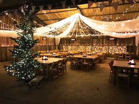 Merry Christmas form The Barn at South Milton, a rustic wedding venue in Devon! Perfectly decorated here for our annual Christmas Party, inspiration for a Christmas or winter wedding! Rustic Christmas Wedding Dress, Christmas Wedding Ceiling Decor, Christmas Party Venue Ideas, Christmas Party Venue Decorations, Christmas Venue Decorations, Country Christmas Theme Party, Warehouse Christmas Party Decor, Christmas Barn Wedding, Country Christmas Party