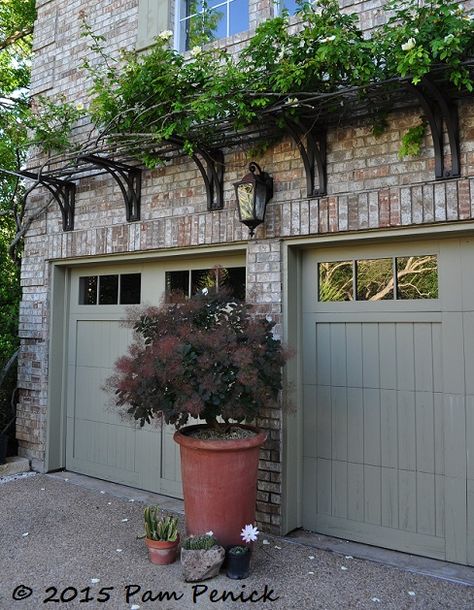 West Texas meets the Big Easy in the courtyard garden of Curt Arnette | Digging. Trellis over garage doors Metal Trellis Over Garage Door, Vine Over Garage, Front Entryway Garden Ideas, Garage Door Trellis Ideas, Trellis On Brick House, Window Trellis Exterior, Garage Trellis Ideas, Arbor Over Garage Door, Arbor Over Garage