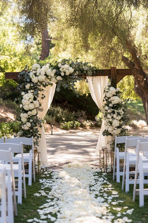 Create a beautiful focal point at your ceremony with stunning wedding arch decoration trends. These unique styles will elevate your vows and create unforgettable memories. Save this pin for more enchanting ideas!  #weddingarch #ceremonydecor #weddingplanning #bridaldecor #weddingideas #weddinginspiration #weddingtrends #archinspiration #rusticwedding #floralarch #bohowedding #outdoorwedding #dreamwedding #weddingdecor #weddingwellness Cute Wedding Venues Outside, Wedding Arch White Flowers And Greenery Simple, Wedding Arch Classic, Floral Arbor Wedding Outdoor Ceremony, White Floral Ceremony Arch, Flowers On Pergola Wedding, Simple Outside Wedding Ceremony, Simple Flower Arch Wedding, Venues For Weddings Outdoor