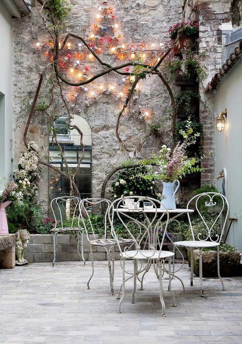 52 Courtyard Ideas to Maximize Your Outdoor Space French Courtyard Garden Ideas, French Courtyard Garden, Courtyard Garden Ideas, French Courtyard, Urban Courtyards, Potted Olive Tree, Patina Farm, Wrought Iron Furniture, Courtyard Design