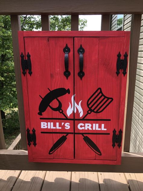 Upgrade your outdoor grill station with a beautiful and functional DIY grill tools organizer and storage cabinet. This cabinet is simple to make and is an easy weekend project. This cabinet features double doors with magnetic catches and holds 4 grill tools. I sized it at 15.5” wide and 19.5“ tall on the interior to fit our BBQ tools. You can easily adjust the size to fit your tools. Decorated with a cool vinyl graphic. Bbq Utensil Storage, Bbq Tools Storage, Utensils Holder Diy, Bbq Utensil Holder, Tool Wall Storage, Grill Accessories Storage, Tools Organizer, Easy Weekend Projects, Outdoor Grill Station