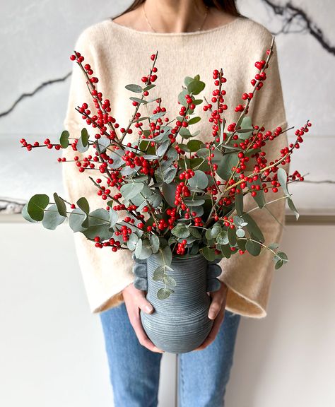 Also known as the winterberry, these premium bright red ilex paired with the relaxing scented eucalyptus are an obvious choice to cozy up any room. They’ll surely make the holidays berry and bright! Arrives in the blue handled vase shown. Overall height, including berry branches, is roughly 17"-18." ❌🐾 Not pet friendly Christmas Branches In Vase, Winter Vase, Faux Flowers Arrangements, Christmas Eucalyptus, Eucalyptus Christmas, Vase Interior, Ideas Decoracion Navidad, Christmas Fireplace Mantels, Holiday Berries