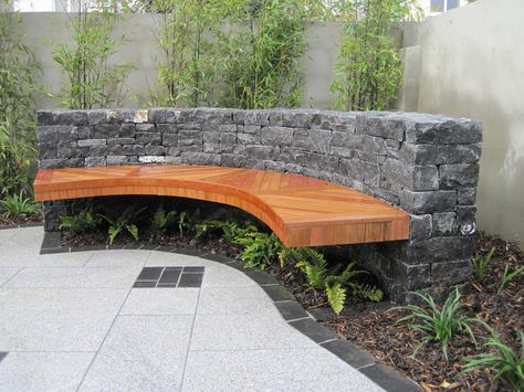 Built in Wooden Curved Garden Bench hung invisibly from a limestone rock wall Curved Outdoor Benches Diy, Curved Garden Wall, Japanese Pool, Curved Outdoor Benches, Retaining Wall Patio, Entry Garden, Curved Patio, Garden Tower, Outdoor Bench Seating