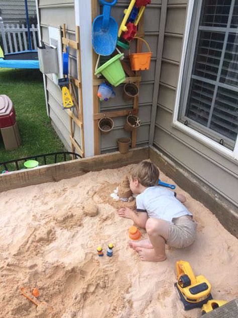 How to build an easy DIY Non-toxic sandbox with built-in drainage, toy organization, a bench, shade, and even a flowerbed! The tip for using gravel and window screen material is genius!! Make your kids summer with this easy DIY! #sandboxideas #sandboxforkids #sandboxbench #sandboxtoystorage #DIYsandbox Sandbox Toy Storage, Corn Sandbox Sand Boxes, Backyard Sandbox Ideas For Kids, Build A Sandbox For Kids, Sand Toy Storage, Sand Box Alternative, Sandbox Toy Storage Ideas, Sandbox Activities, Diy Sand Box For Kids