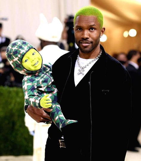 Frank Ocean brought a green robotic baby with him to the 2021 Met Gala on Monday evening.The experimental R&B star wore a black Dreamcore cap and at times also showed off his neon-green hair. He dazzled in a black Prada jacket, similar to the nylon gabardine anorak jacket he wore at the 2019 Met Gala. Ocean's new independent American luxury brand Homer recently partnered with Prada on a collection."In America ... I feel like we do kinda make, set some trends in general, especially in music," Frank Ocean Hair Color, Frank Ocean Green Hair, Frank Ocean Hair, Frank Ocean Green, Neon Green Hair, Ocean Hair, Prada Jacket, Channel Orange, People References