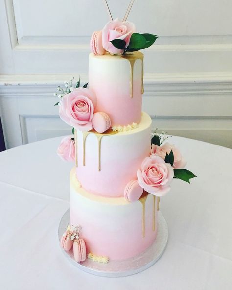 Three tier wedding cake with soft pink ombré, gold drip, macarons and fresh flowers / foliage Pink And Gold Two Tier Cake, Pink Ombre Cake With Flowers, Pink Three Tier Cake, Wedding Cake With Macarons And Flowers, Pink 2 Tier Birthday Cake, Ombr�é Pink Cake, Three Tier Wedding Cake With Flowers, Birthday Cake Three Tier, Tiered Drip Cake