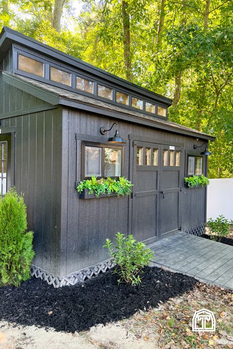 We love this modern shed workshop! There's charm inside and out of Cass' woodworking and DIY workshop shop, and it's filled with so many personal customizations and DIY design ideas. With an all-black paint scheme and bright exterior lighting, these beautiful shed design ideas make for a perfect backyard workshop shed. Add the space you need for DIY projects and infuse your style into your new backyard shed with inspiration from this modern shed workshop, filled with storage ideas and designs. Small Workshop Shed Ideas, Around The Shed Landscaping, Shrubs Around Shed, Shed With Planter Boxes, Shed Addition To House, Black Outdoor Shed, Attached Shed To House, Custom Sheds Ideas, Diy Workshop Building