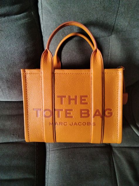 Marc Jacobs Tote Bag in the color: SCORCHED The Tote Bag Leather Marc Jacobs, Marc Jacobs Sack Bag, Luxury Orange Tote Bag, Orange Marc Jacobs Bag, Yellow Marc Jacobs Bag, Marc Jacobs Tote, Marc Jacobs, Orange, Tote Bag