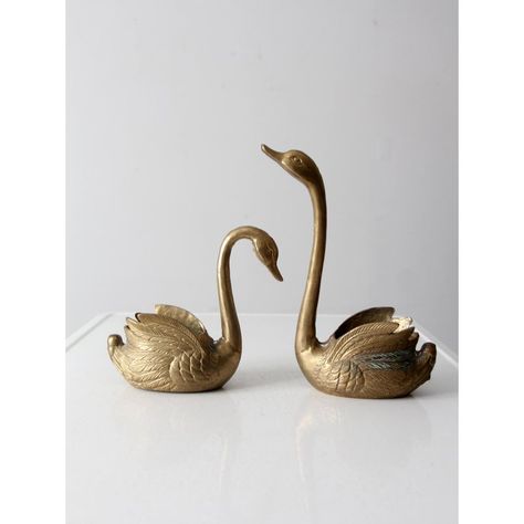 These vintage mid 20th century brass swan planters add a beautiful decorative touch to any room. Crafted from cast brass with intricate detailing, they can be used as cachepots or decorative bowls.    MEASUREMENTS Swan 1:  8.5" x 3.25" x 7.75" H  ..  21.6 cm x 8.3 cm x 19.7 cm Swan 2:  8.25" x 3.25" x 11.5" H  ..  21 cm x 8.3 cm x 29.2 cm Brass Swans Decor, Swan Accessories, Swan Nursery Decor, Mid Century Glam, Wooden Crate Boxes, Vintage Brass Decor, Swan Decor, Brass Swan, Brass Animals