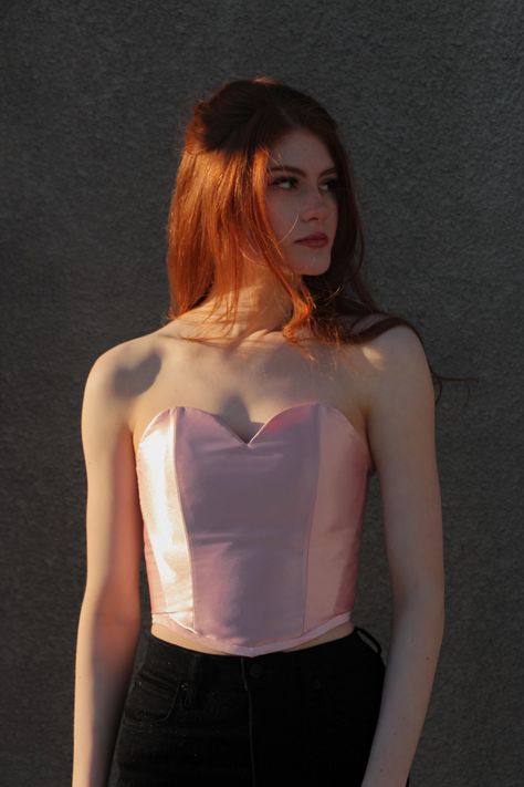 A red headed model is wearing a pink satin heart shaped corset top. This corset is exclusively made & sold by I. M. WALKER. Corset Shirt Outfit, Heart Shaped Corset, Heart Corset, Crop Top Satin, Sweetheart Corset, Fashion Corset, Satin Bustier, Tops Trendy, Corset Shirt