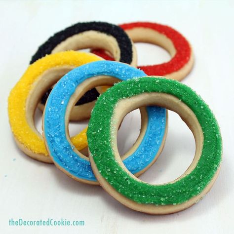 I originally made these Olympic rings cookies for Bird’s Party Magazine, along with these mini Olympics cupcakes for the Summer games. They are crazy easy for anyone to make since the sprinkles cover all imperfections.     how to make Olympic rings cookies    You will need:* cut-out cookie dough and royal icing ...Read More » Olympic Desserts, Olympic Party Food, Olympic Snacks, Summer Olympics Party, Olympic Food, Olympic Theme Party, Halloween Sugar Cookies Decorated, Olympic Idea, Olympic Crafts