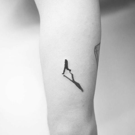 Black tattoo of a walking man’s silhouette Walk In Tattoos, 22 Tattoo, Tatuagem Masculina Pequena, Wrist Tattoos For Guys, Silhouette Tattoos, Tattoos Geometric, Modern Tattoos, Small Tattoos For Guys, Tattoo Kits