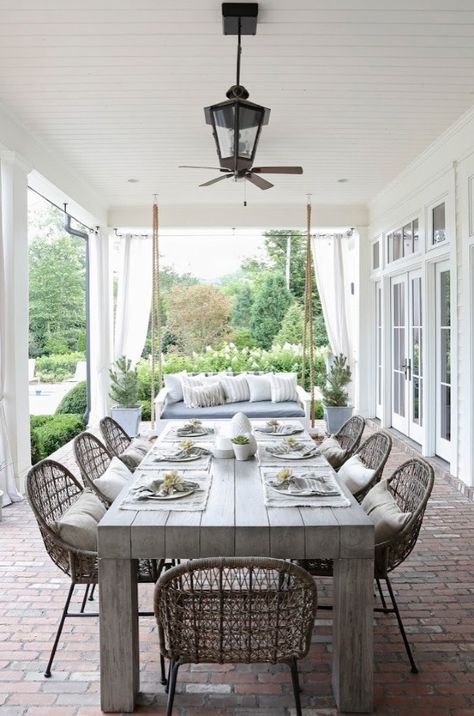 "We really wanted to make sure that the outdoor dining was as Southern as the house," says April of this porch project, "but we still wanted it to be youthful." She chose a classic Southern swing and table, adding chairs with a bit more spunk. April Tomlin Exterior, Porch Furniture Ideas Outdoor, April Tomlin, Patio Dining Area, Porch Dining, Design Per Patio, Dinning Tables, Dining Outdoor, Patio Layout